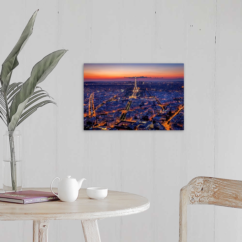 A farmhouse room featuring An aerial photograph of Paris at night with the Eiffel tower seen standing tall.