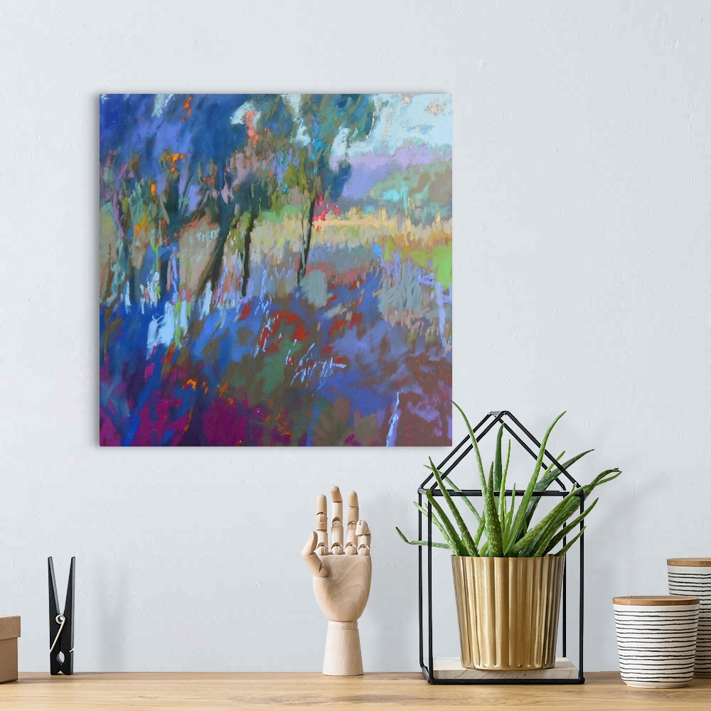A bohemian room featuring Colorful contemporary landscape painting using deep tones of blue.