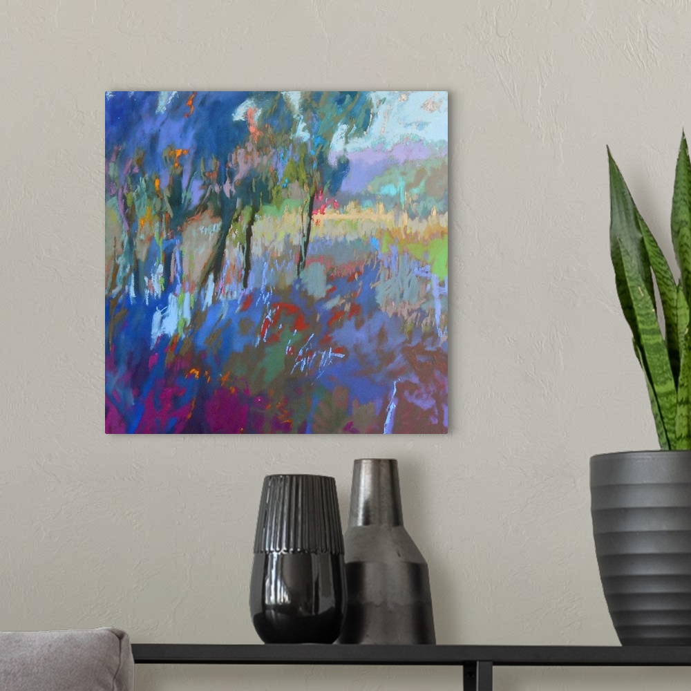 A modern room featuring Colorful contemporary landscape painting using deep tones of blue.