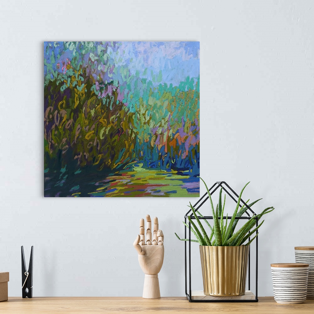 A bohemian room featuring A square abstract of plants painted with brush strokes of vibrant colors.