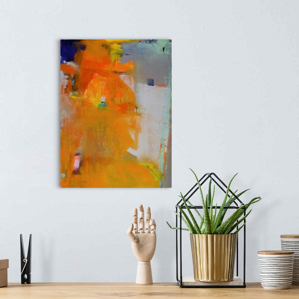 A bohemian room featuring Contemporary abstract painting in brilliant orange hues on a gray background.