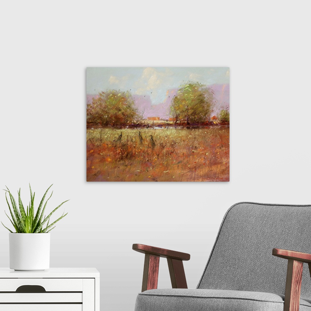 A modern room featuring A contemporary painting of a southwestern landscape with birds hiding in tall grass.