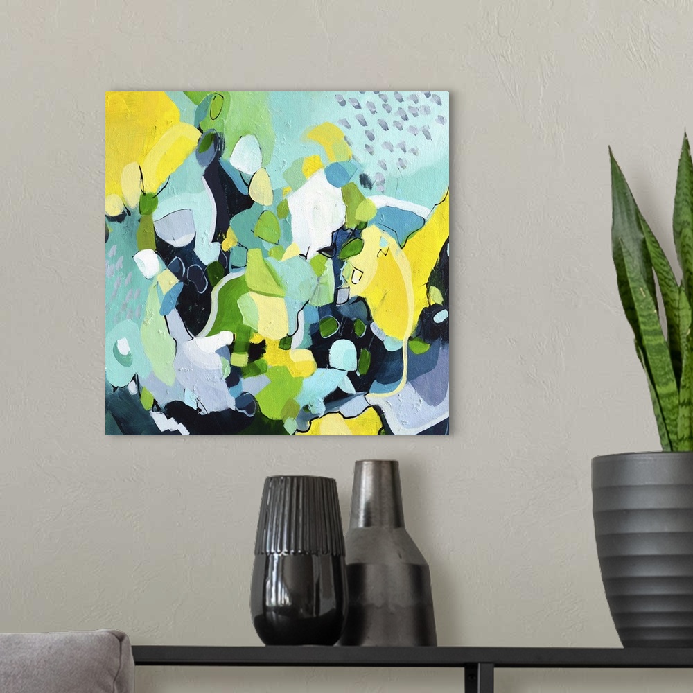 A modern room featuring Festive abstract painting with blue, green, and yellow shapes.