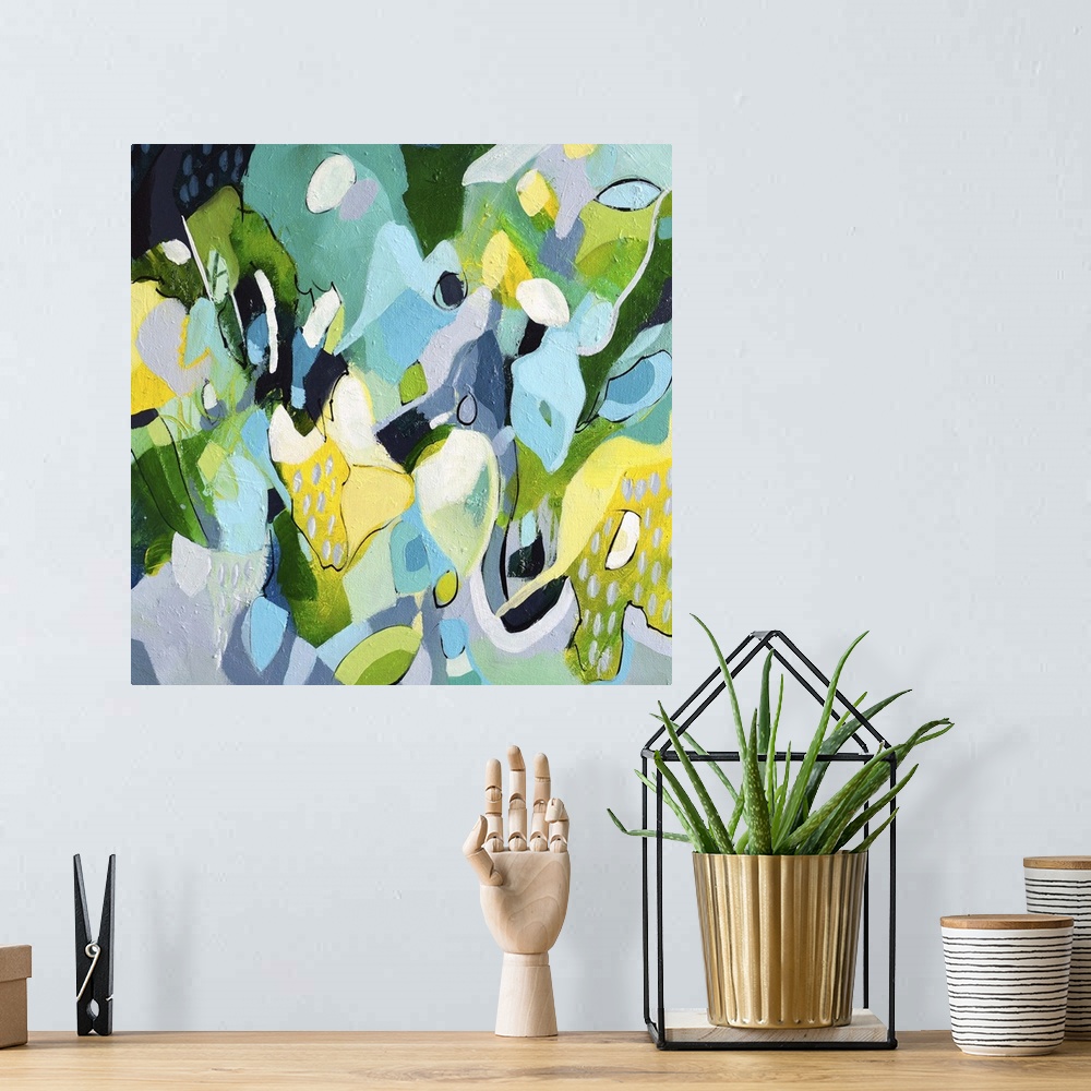 A bohemian room featuring Festive abstract painting with blue, green, and yellow shapes.