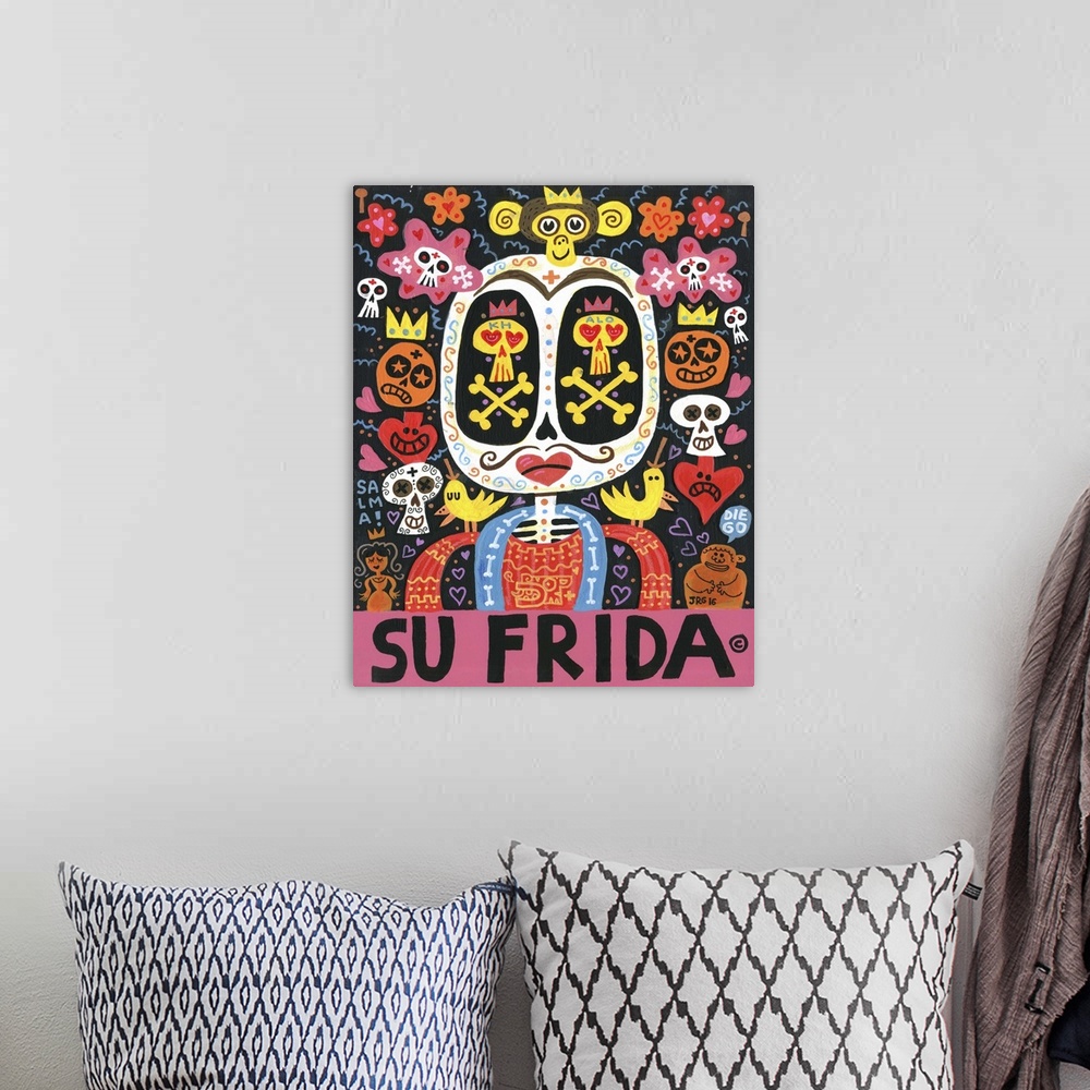 A bohemian room featuring Latin art of a sugar skull decorated with hearts and flowers.