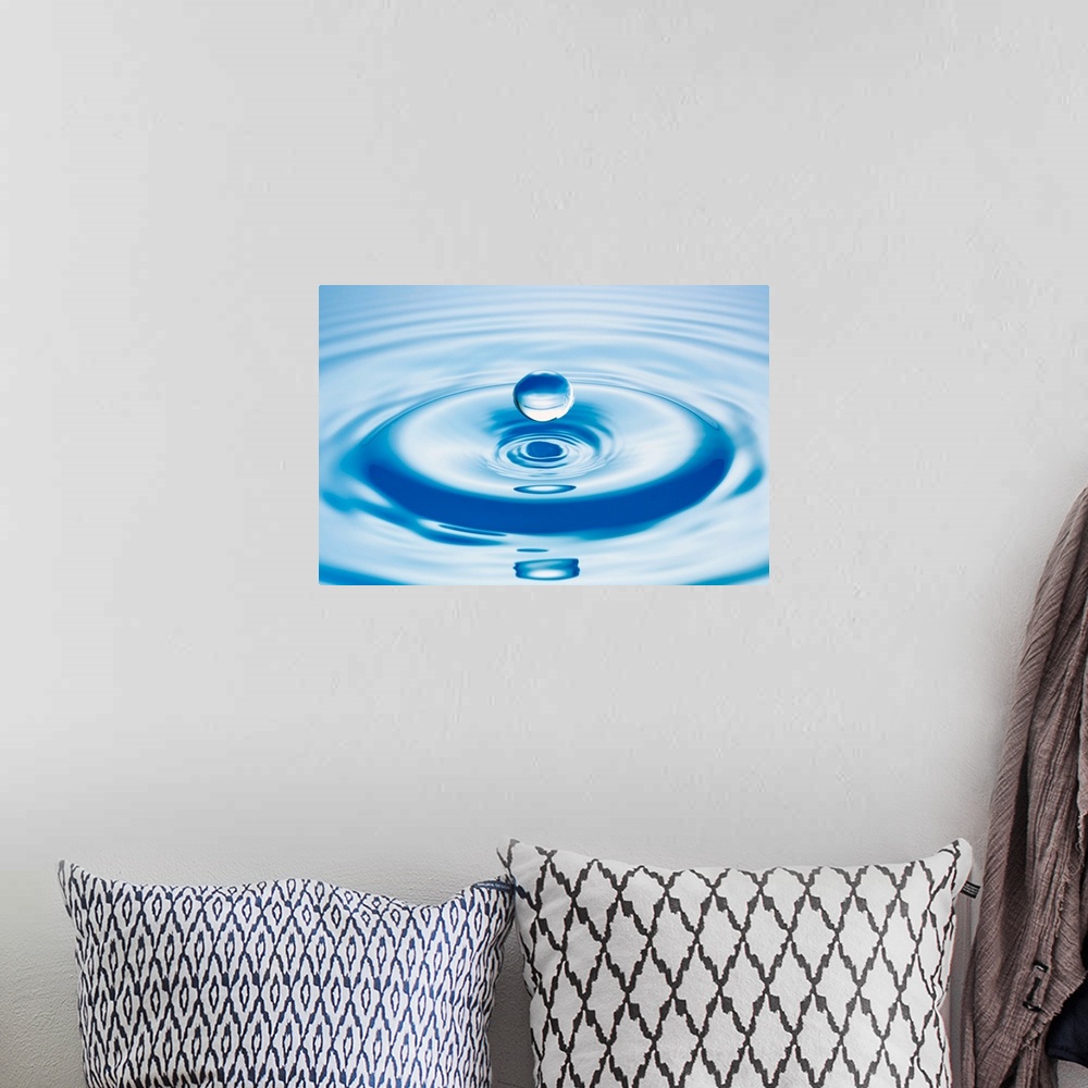 A bohemian room featuring Horizontal close up photograph of a drop of water with ripples.