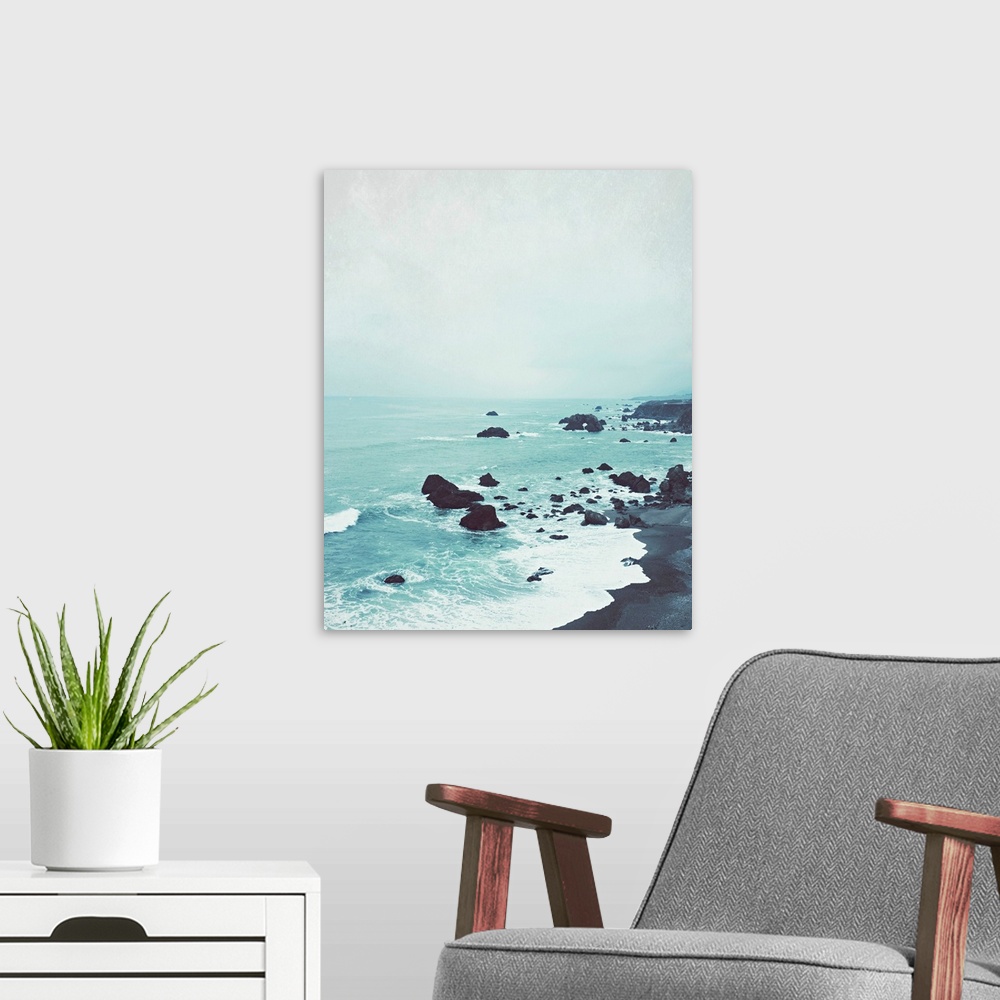 A modern room featuring Photography of a peaceful rock beach at dusk.
