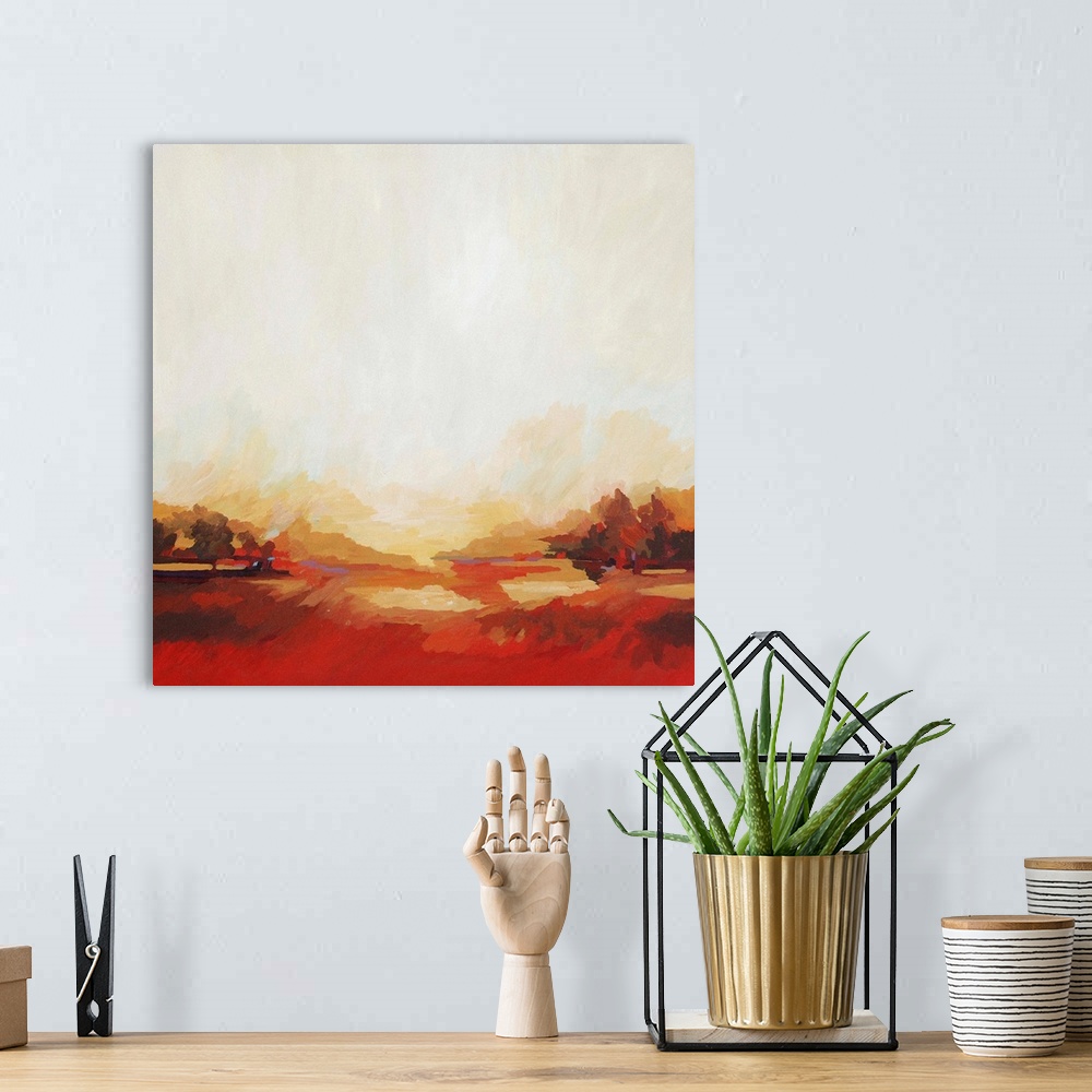A bohemian room featuring A contemporary abstract painting of a red landscape under a light cream sky.