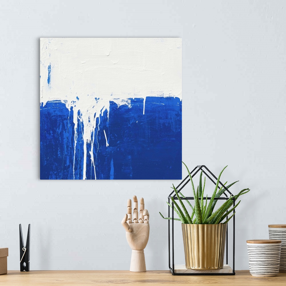 A bohemian room featuring Contemporary abstract colorfield painting using deep blue and white in a distressed style.
