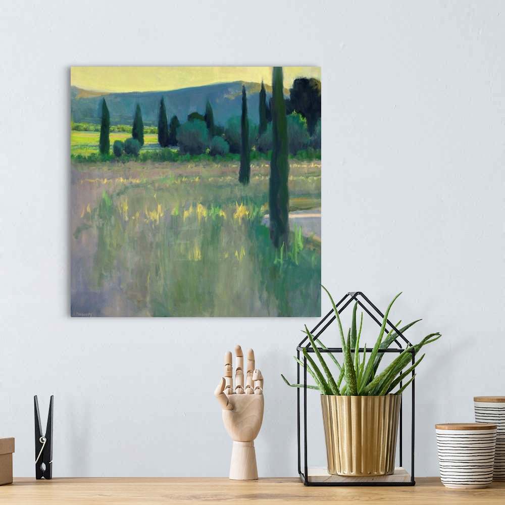 A bohemian room featuring A contemporary landscape painting with tall thin trees.