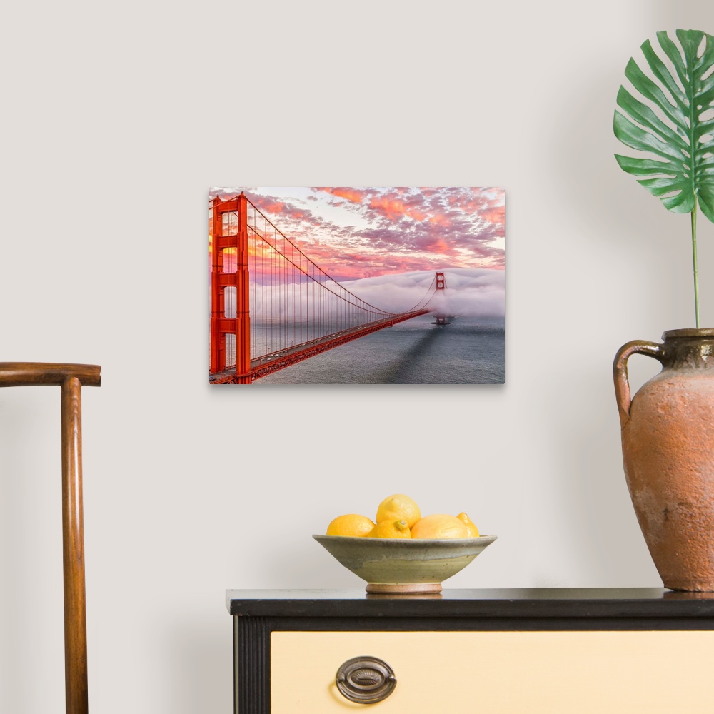 A traditional room featuring A dynamic photograph of the golden gate bridge disappearing in a thick blanket of clouds.