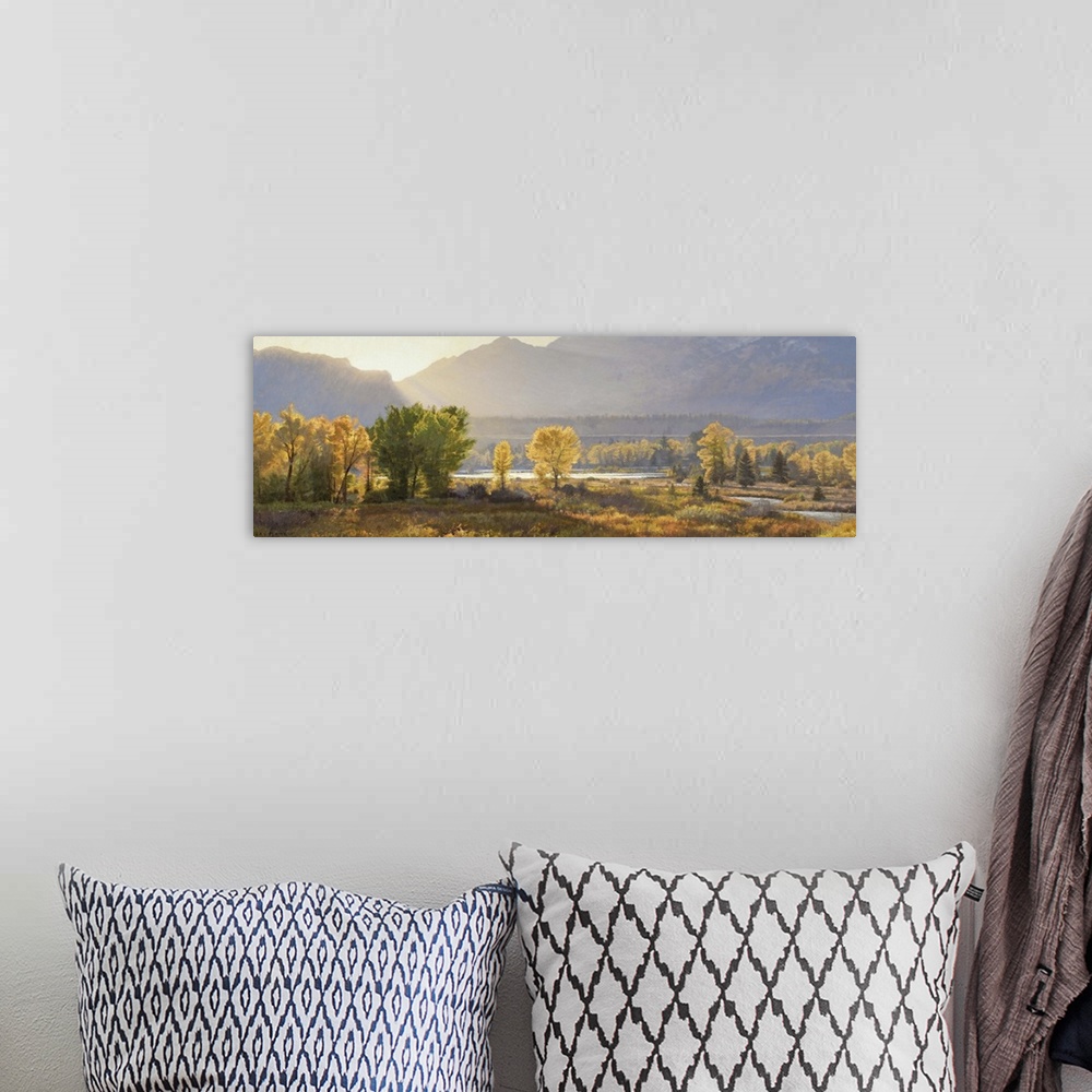 A bohemian room featuring A contemporary landscape painting of a mountain scene at sunset.