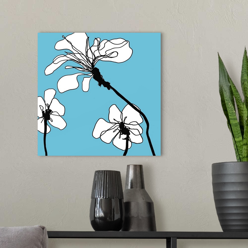 A modern room featuring Modern artwork of white flowers on a blue backdrop.