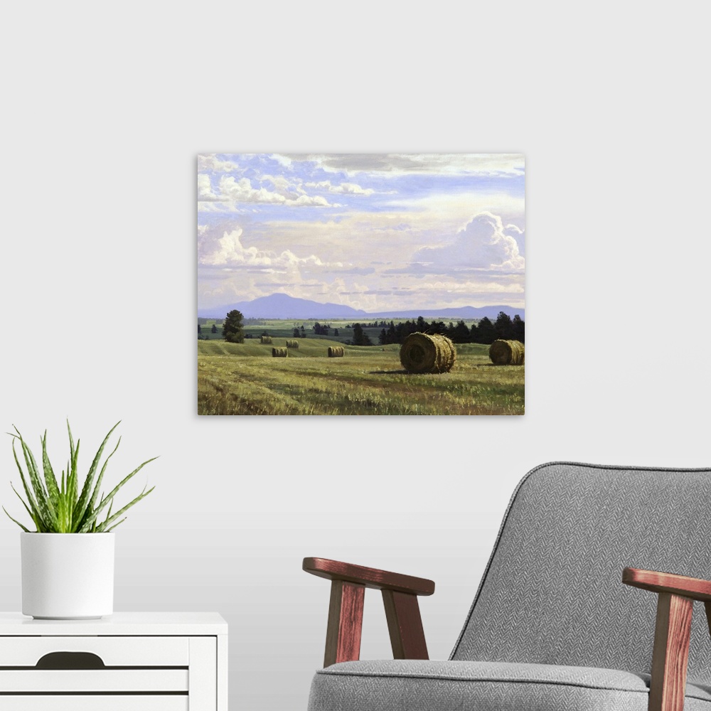 A modern room featuring A contemporary landscape painting of freshly cut hay bails sitting in a countryside field.