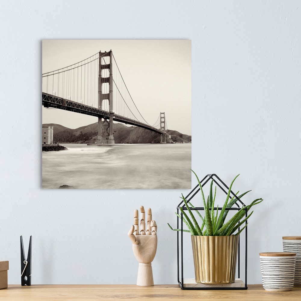 A bohemian room featuring A black and white photograph of the Golden Gate Bridge in San Francisco.