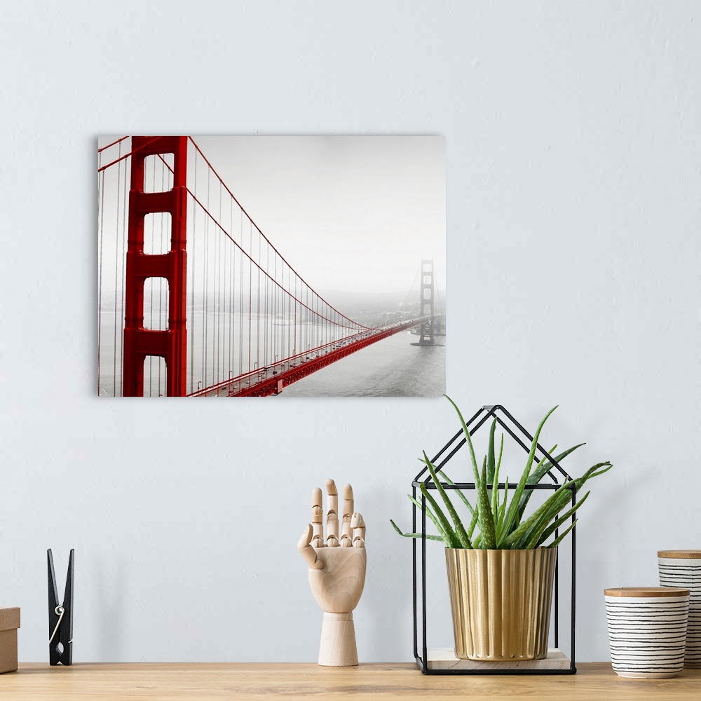 A bohemian room featuring Horizontal photograph of the Golden Gate Bridge in fog in black and white with selective color on...