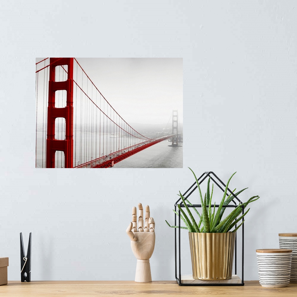 A bohemian room featuring Horizontal photograph of the Golden Gate Bridge in fog in black and white with selective color on...
