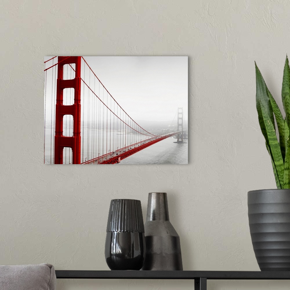 A modern room featuring Horizontal photograph of the Golden Gate Bridge in fog in black and white with selective color on...