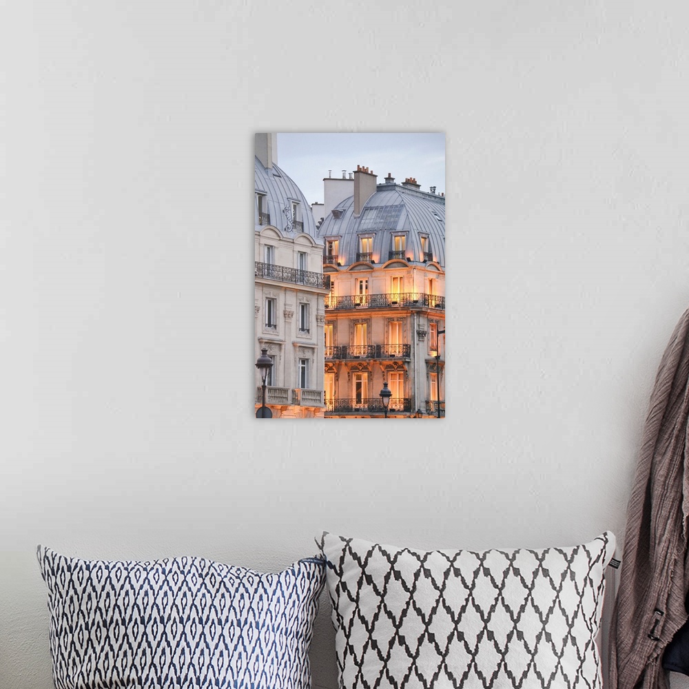 A bohemian room featuring A photograph of Paris apartment buildings at dusk with lights beginning to warm the faade