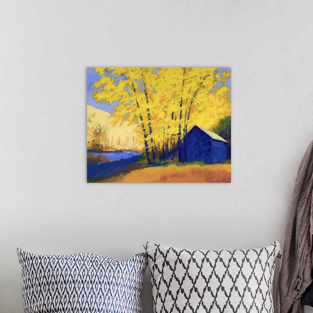 A bohemian room featuring A contemporary painting of a building and trees with yellow leaves.