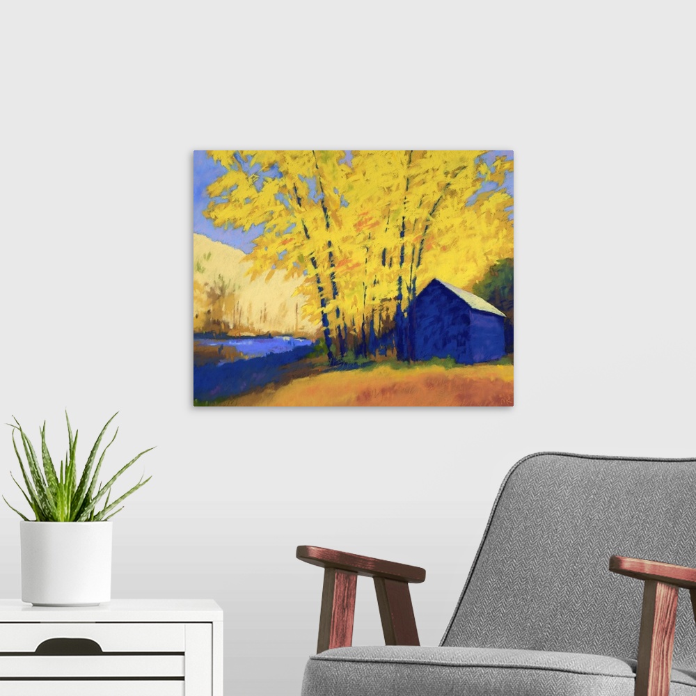 A modern room featuring A contemporary painting of a building and trees with yellow leaves.