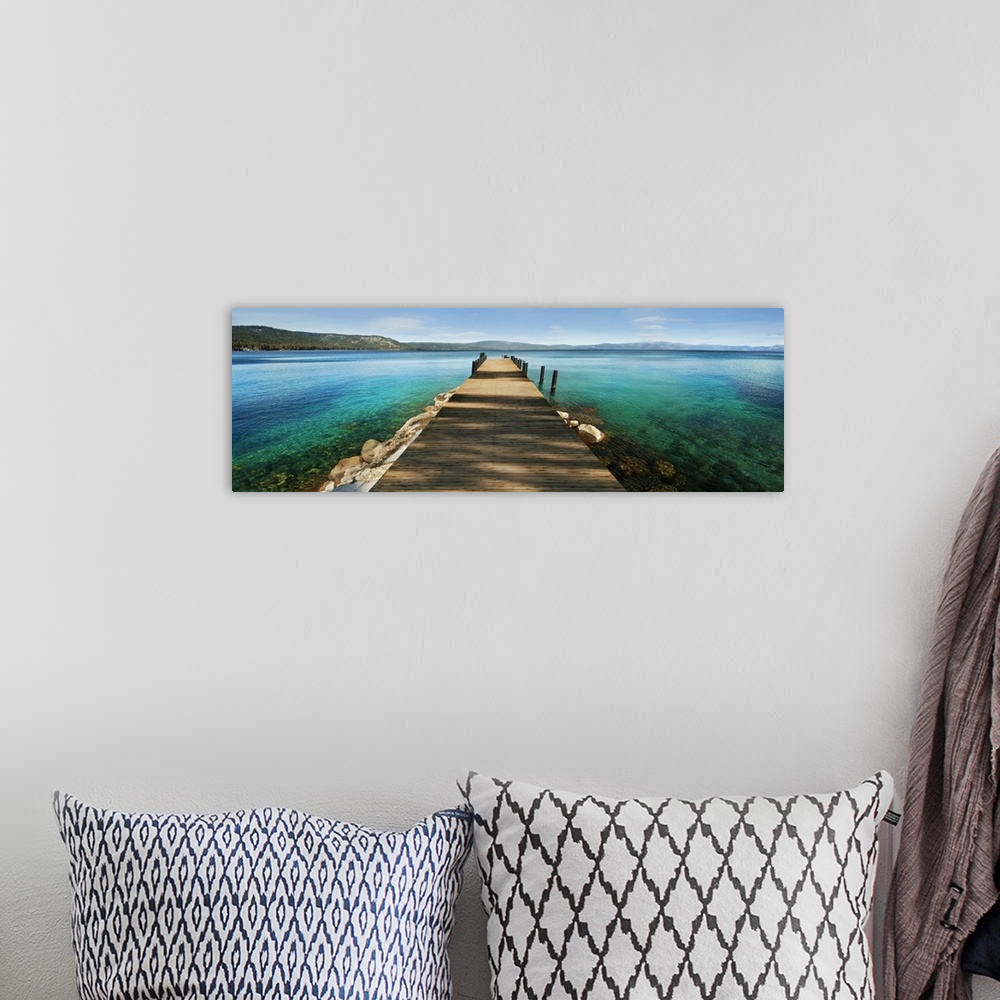A bohemian room featuring A photograph of a dock jetting out over vibrant crystal water in a tropical paradise.