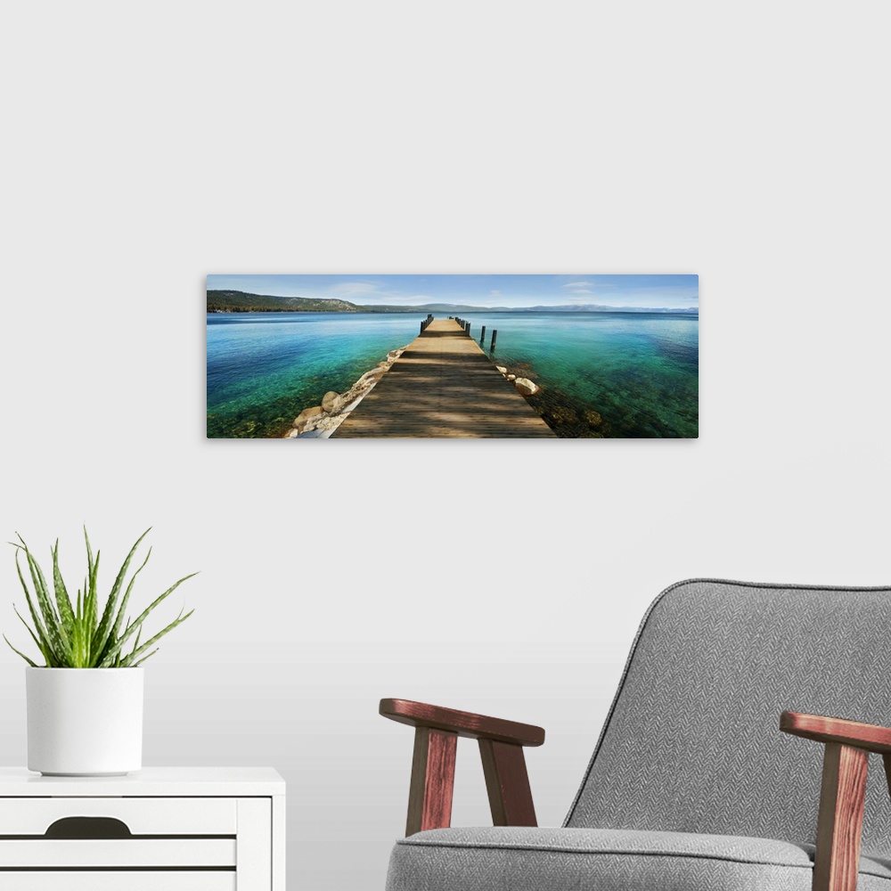 A modern room featuring A photograph of a dock jetting out over vibrant crystal water in a tropical paradise.