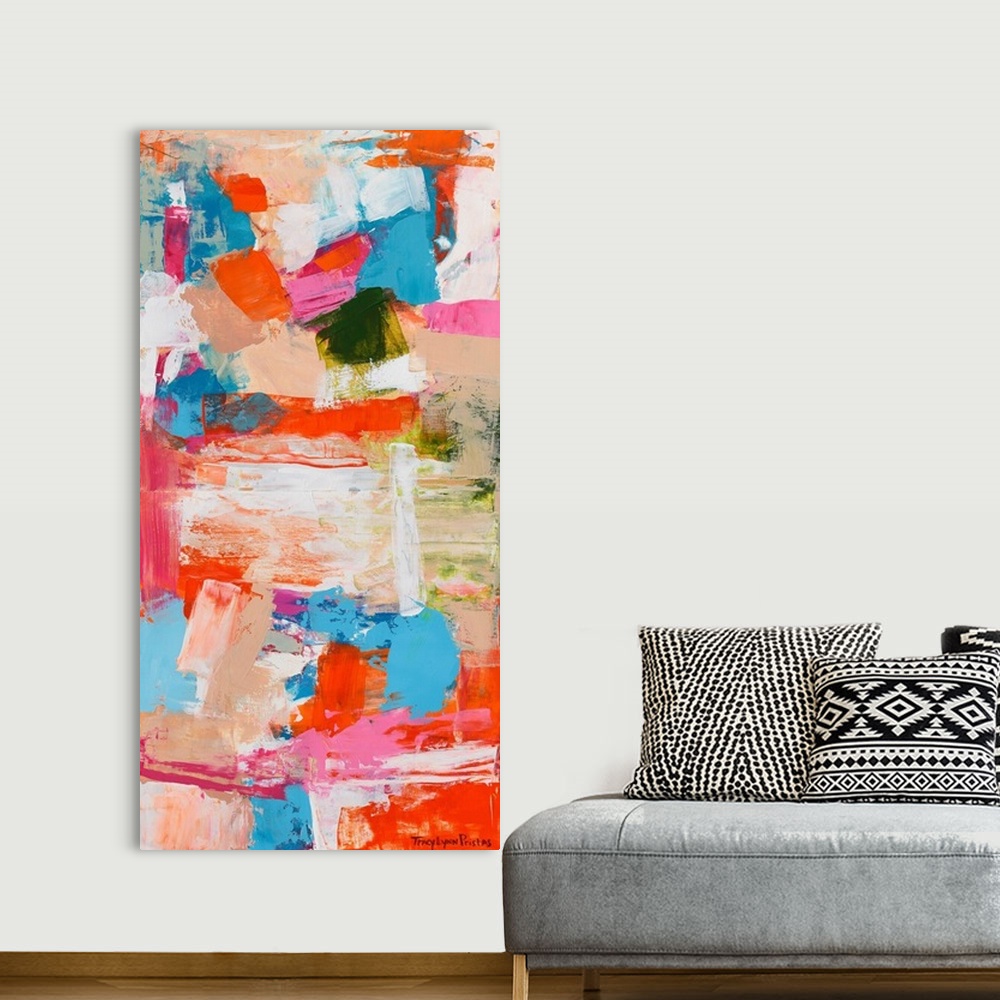 A bohemian room featuring A contemporary abstract painting of intense shades of of orange, pink, and tan.