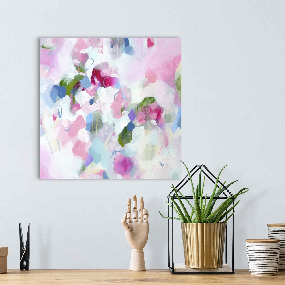 A bohemian room featuring Abstract artwork in cheerful shades of pink, white, and blue.