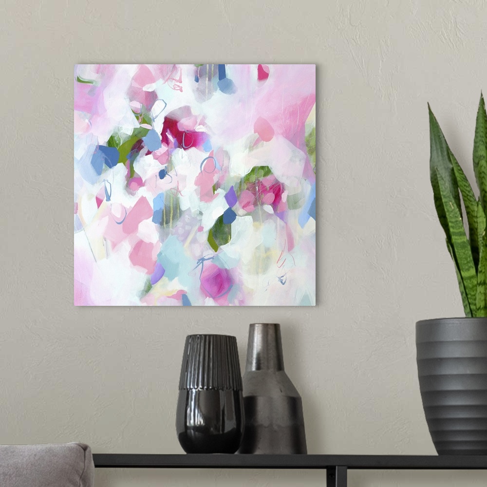 A modern room featuring Abstract artwork in cheerful shades of pink, white, and blue.