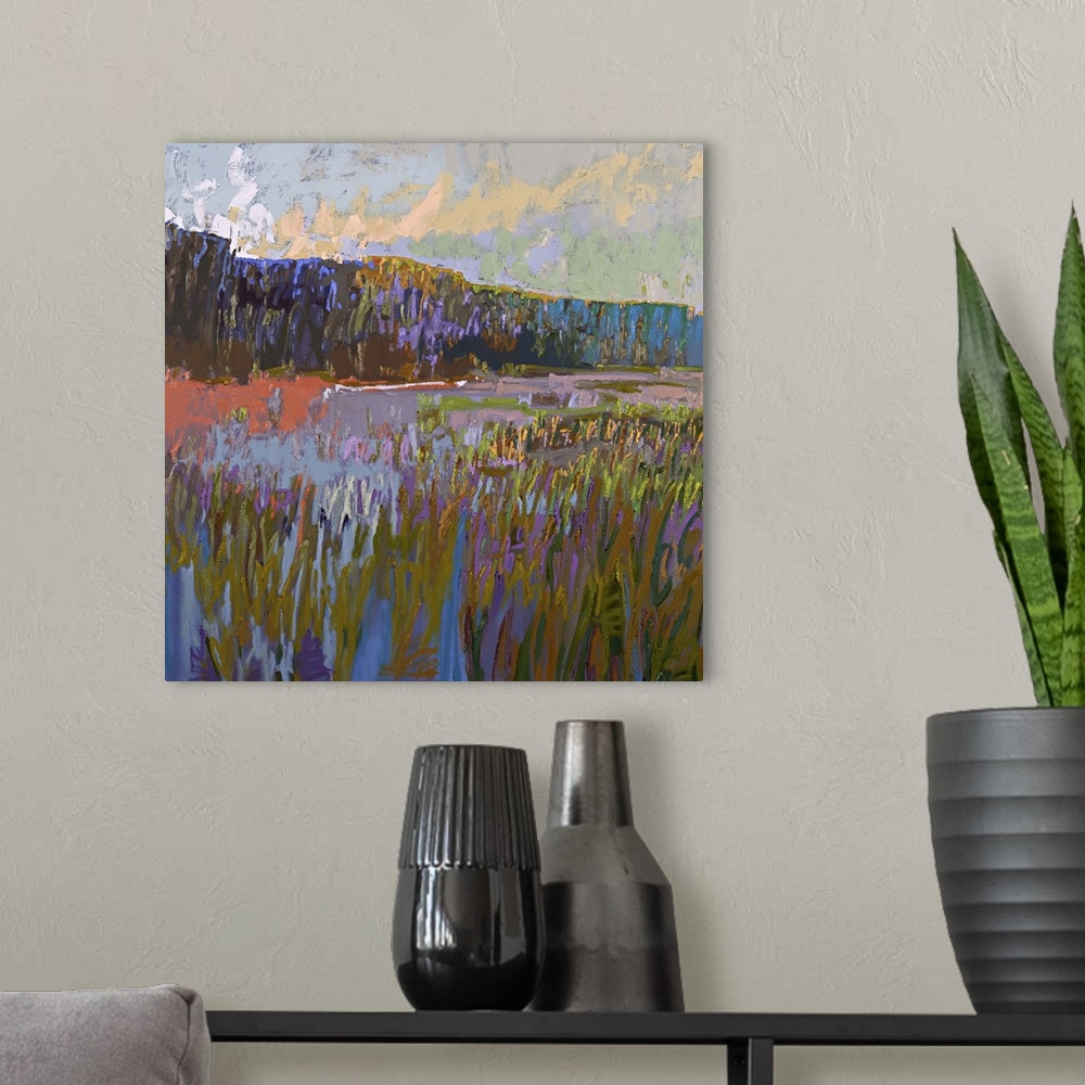 A modern room featuring Contemporary landscape painting of a grassy field at sunset.