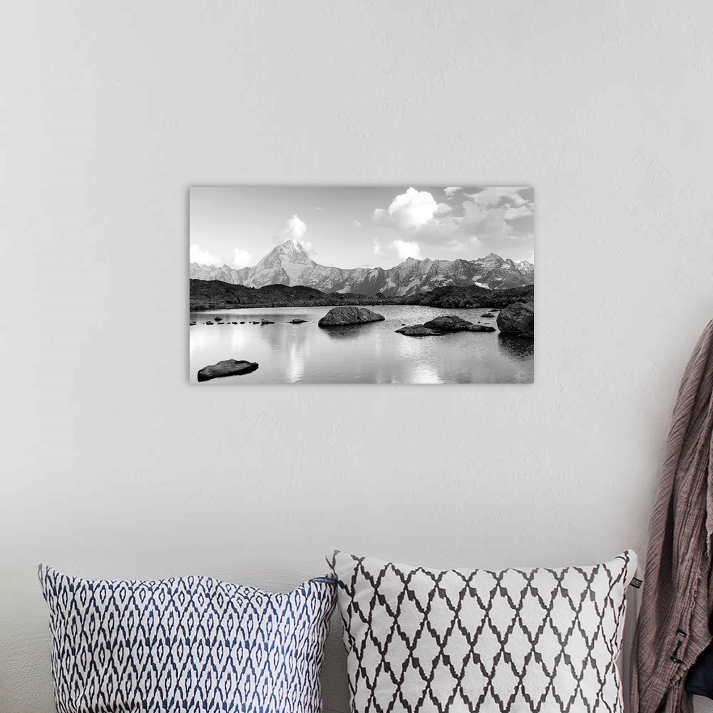 A bohemian room featuring Black and white landscape image of a lake with snow covered mountains in the background.