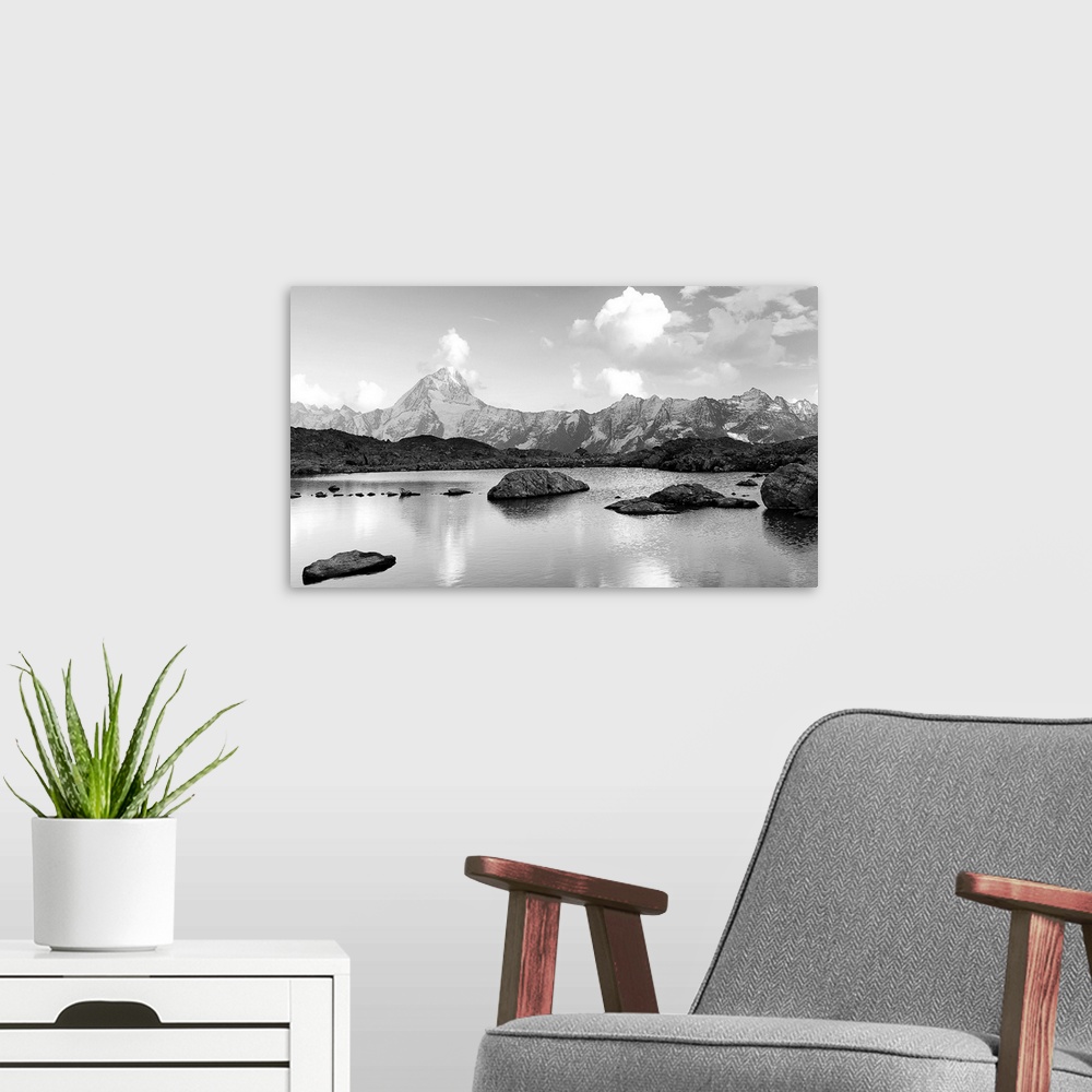 A modern room featuring Black and white landscape image of a lake with snow covered mountains in the background.