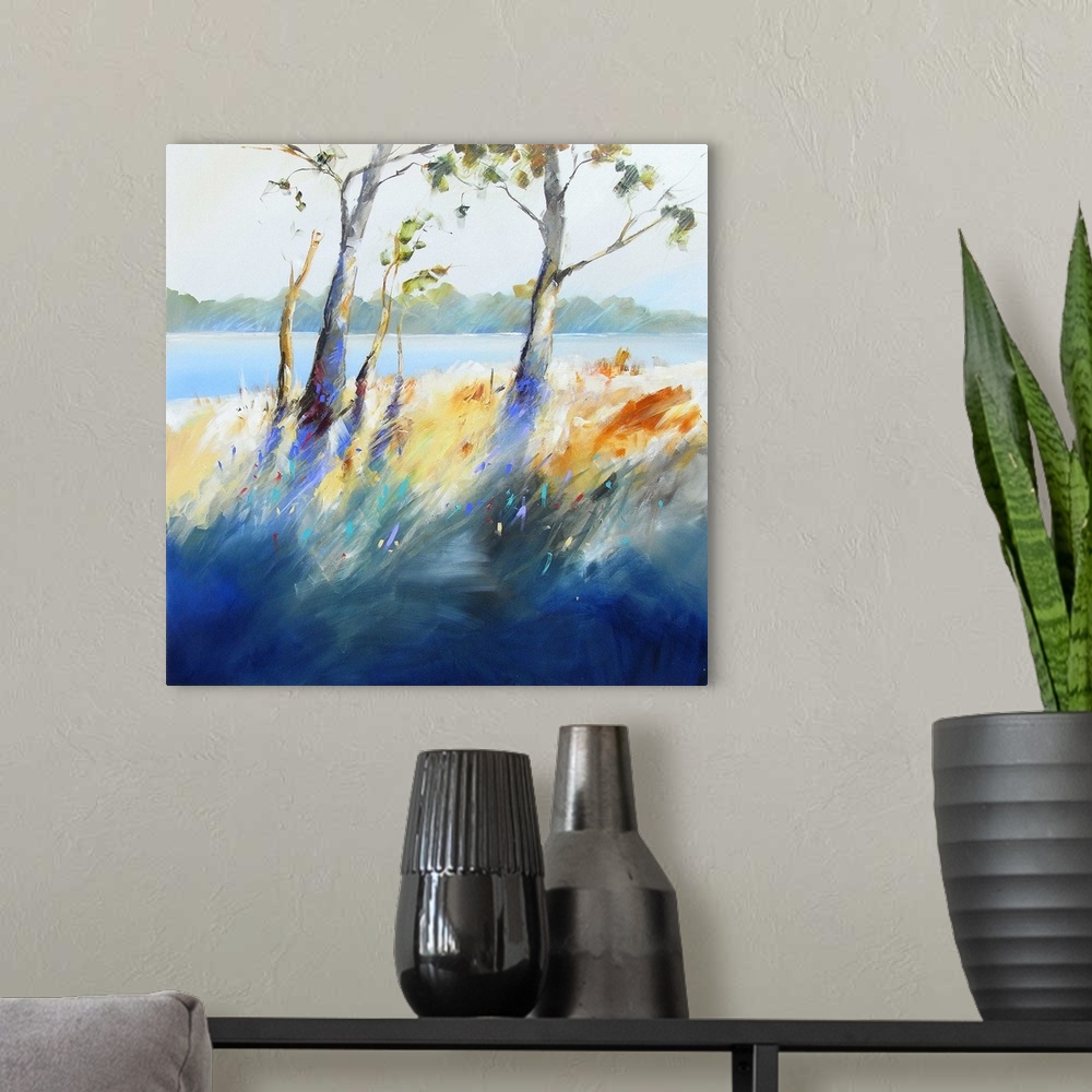 A modern room featuring Contemporary painting of trees and grass growing next to a river.