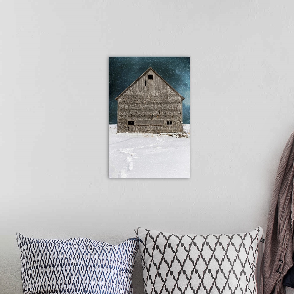 A bohemian room featuring An old abandoned barn in a winter snow storm with footprints.