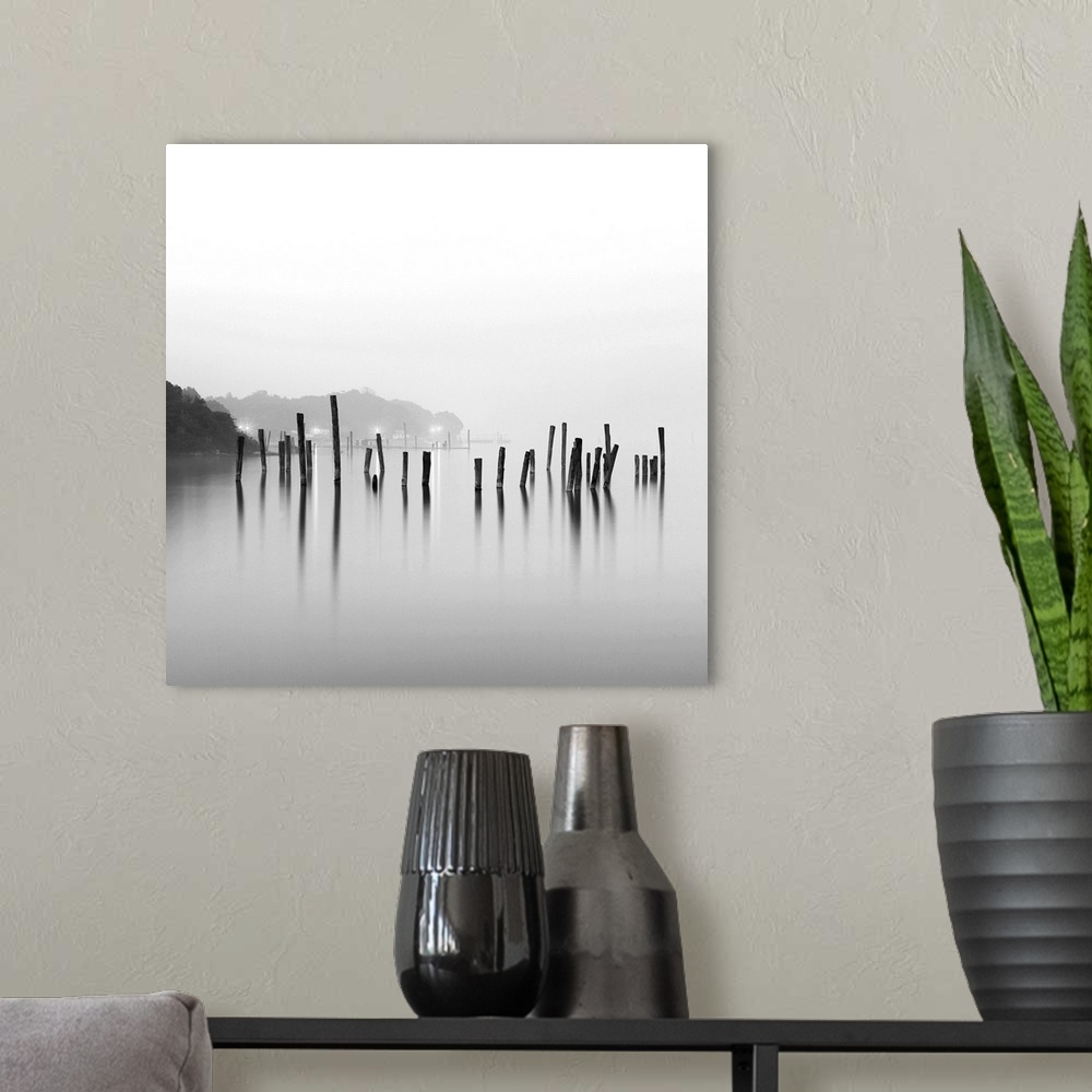 A modern room featuring Black and white square image of an old pier in mist.