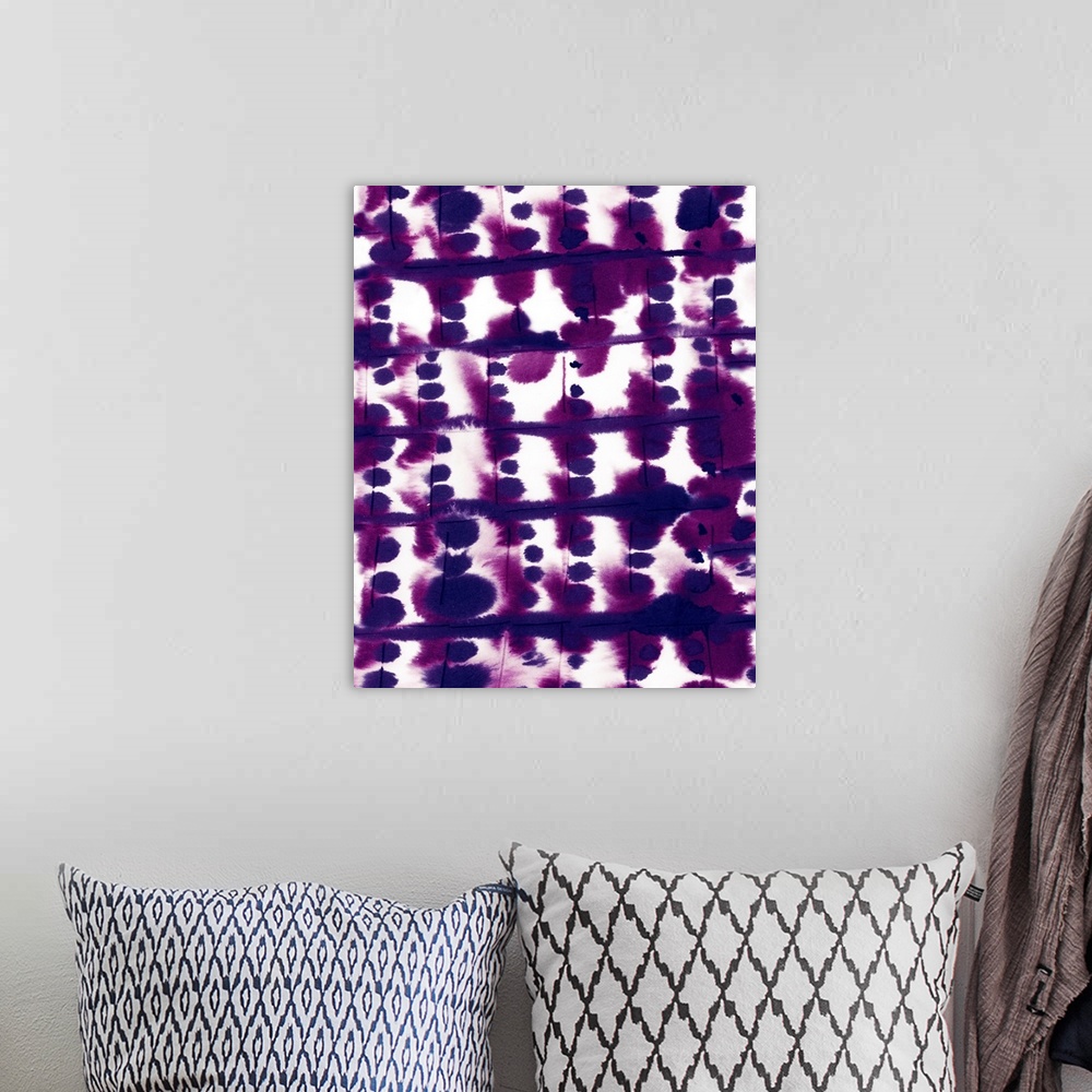 A bohemian room featuring A vertical abstract watercolor painting in deep purple.