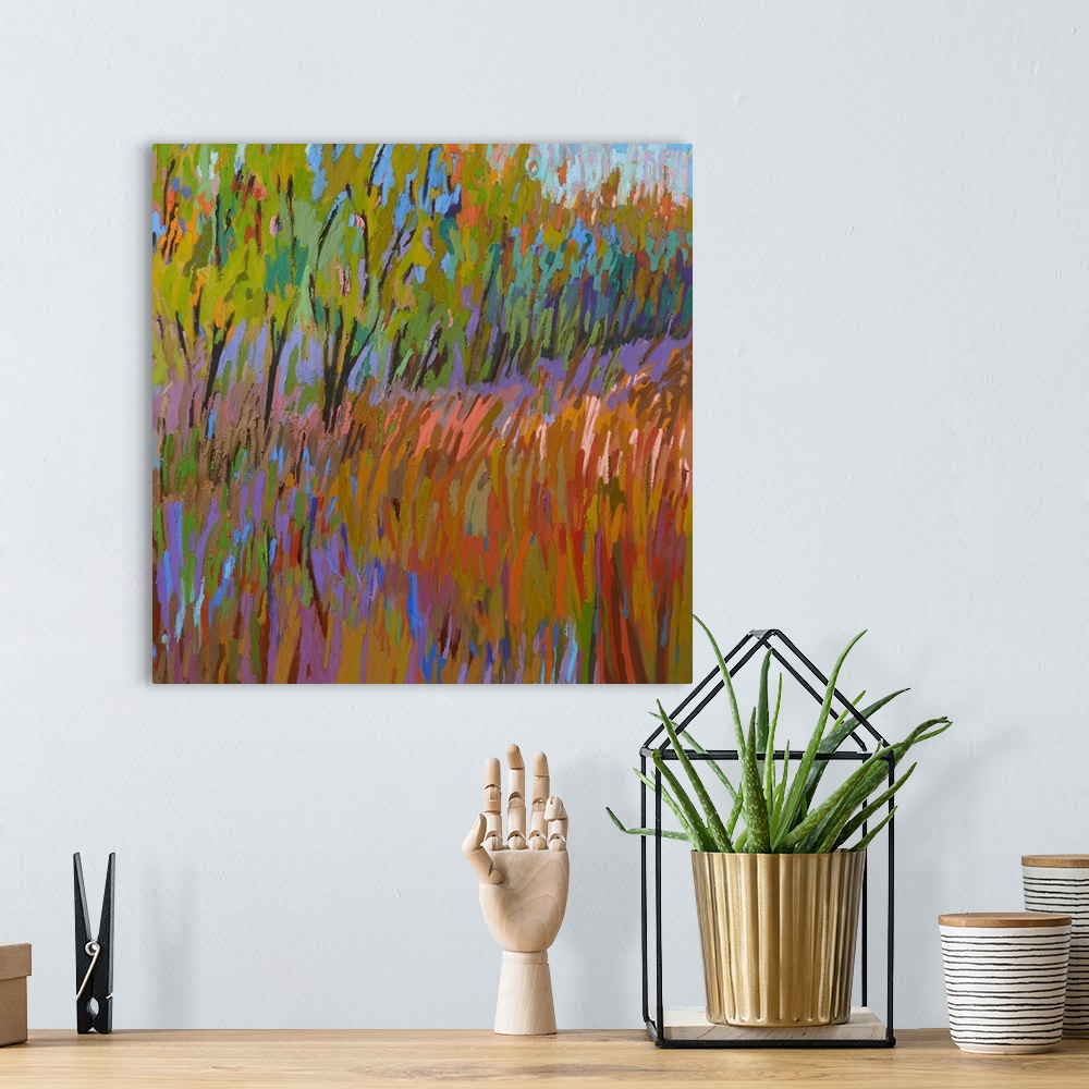 A bohemian room featuring A square abstract of trees and a field painted with brush strokes of vibrant colors.