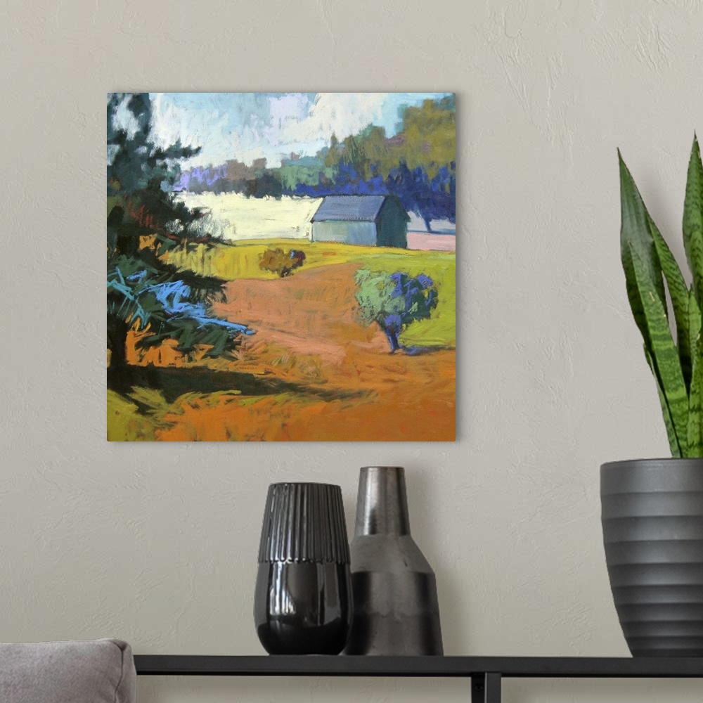 A modern room featuring Colorful contemporary landscape painting using deep tones of orange.