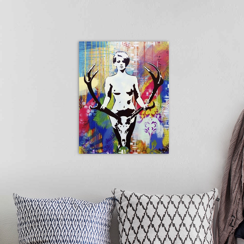 A bohemian room featuring Urban painting of a nude woman holding a large pair of antlers.