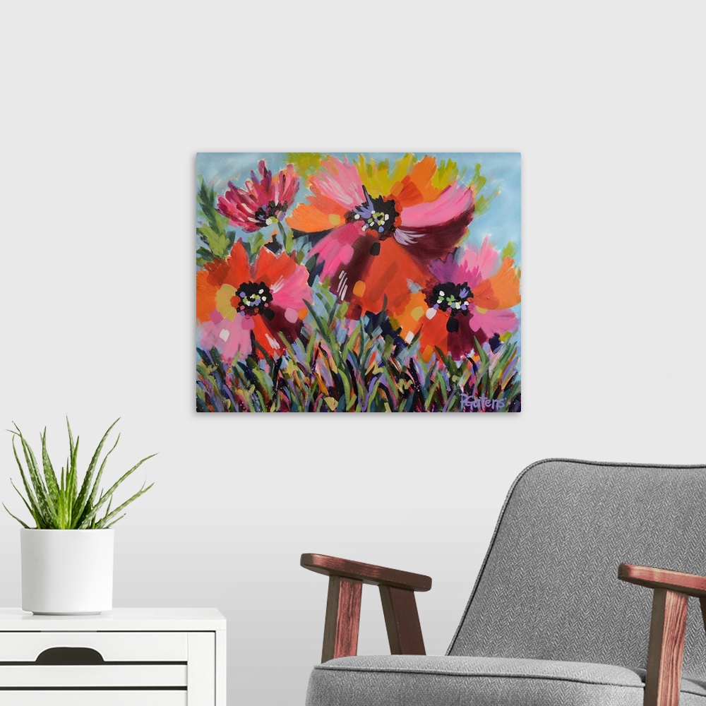 A modern room featuring A horizontal abstract painting of bright poppies in colors of yellow, orange and pink.