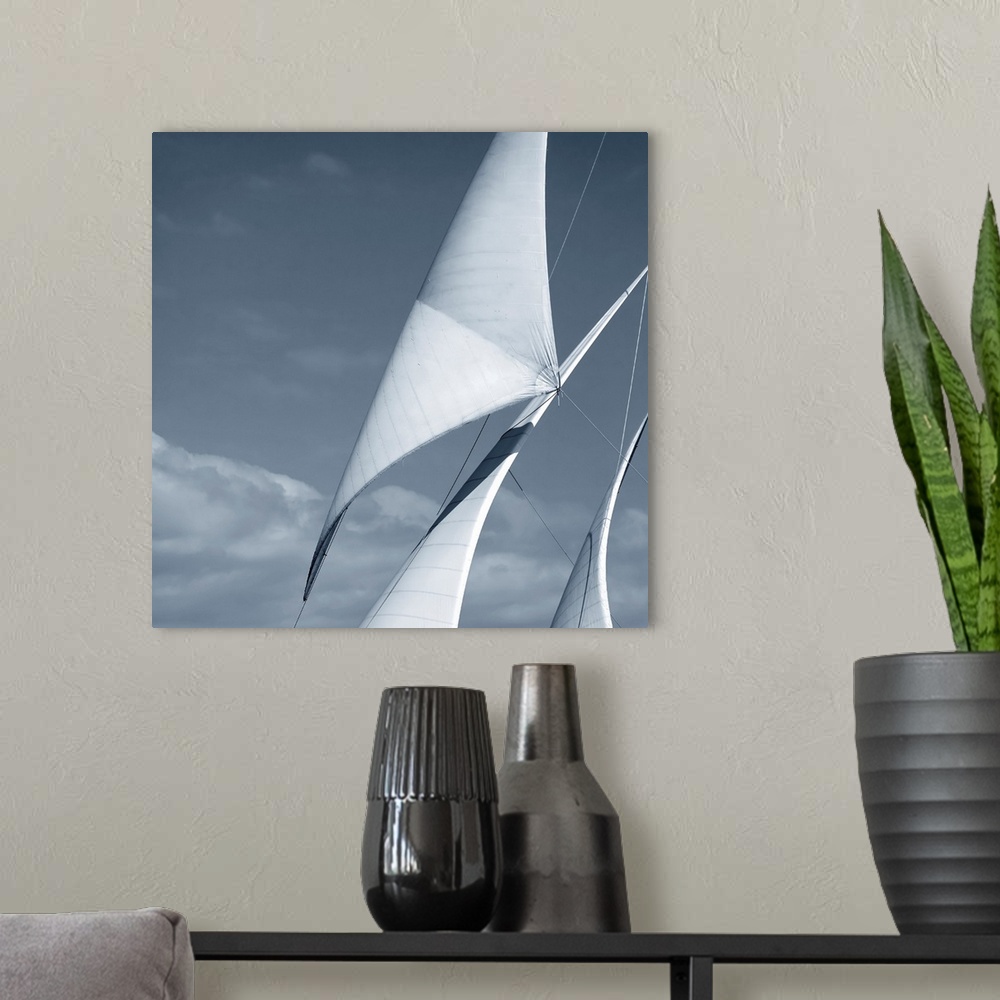 A modern room featuring Black and white photograph of three sails against a cloudy sky.