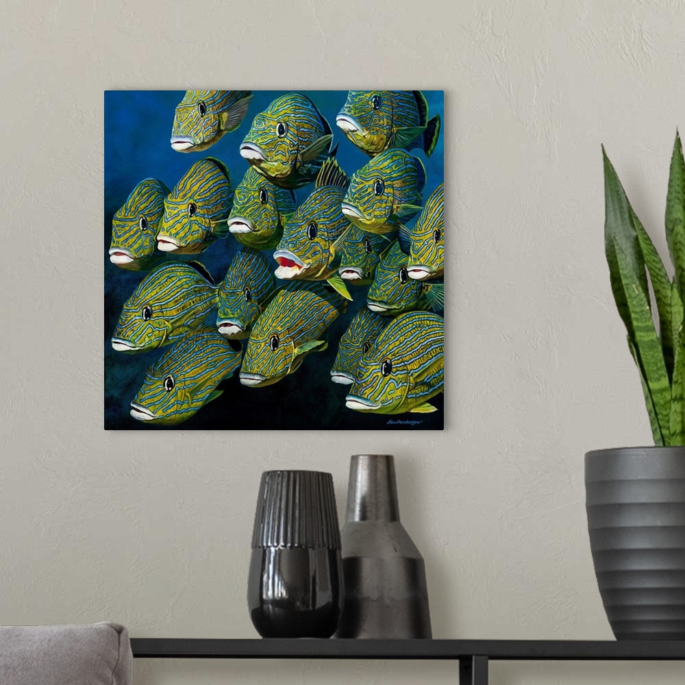 A modern room featuring A square painting of a shoal of colorful Grunts.