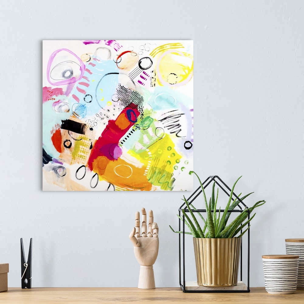A bohemian room featuring A colorful contemporary abstract piece of art using wild colors and shapes.