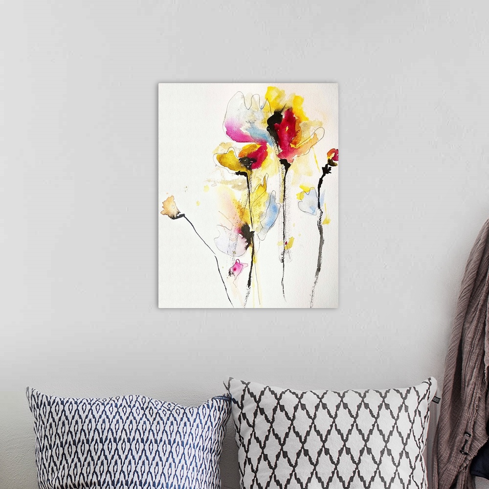 A bohemian room featuring Contemporary watercolor painting of vibrant colored yellow and red flowers.