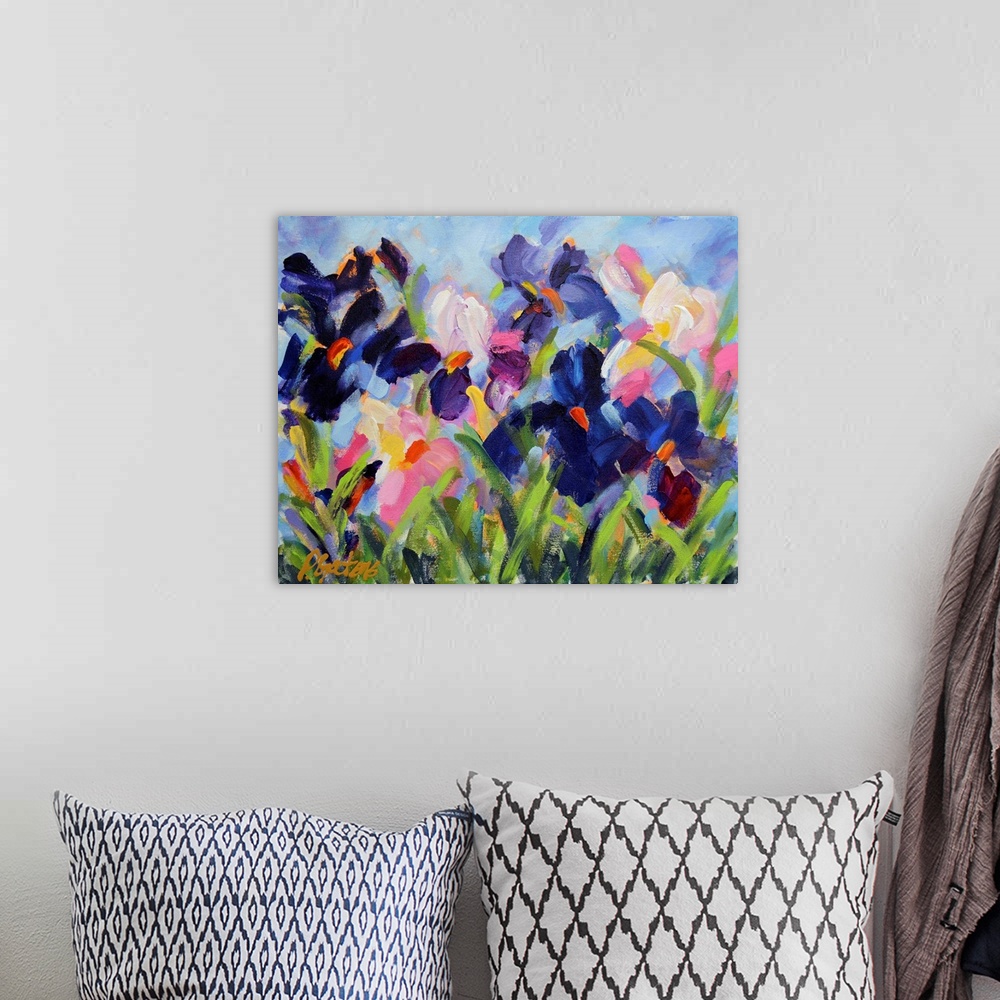 A bohemian room featuring A horizontal abstract painting of irises in colors of purple and white.