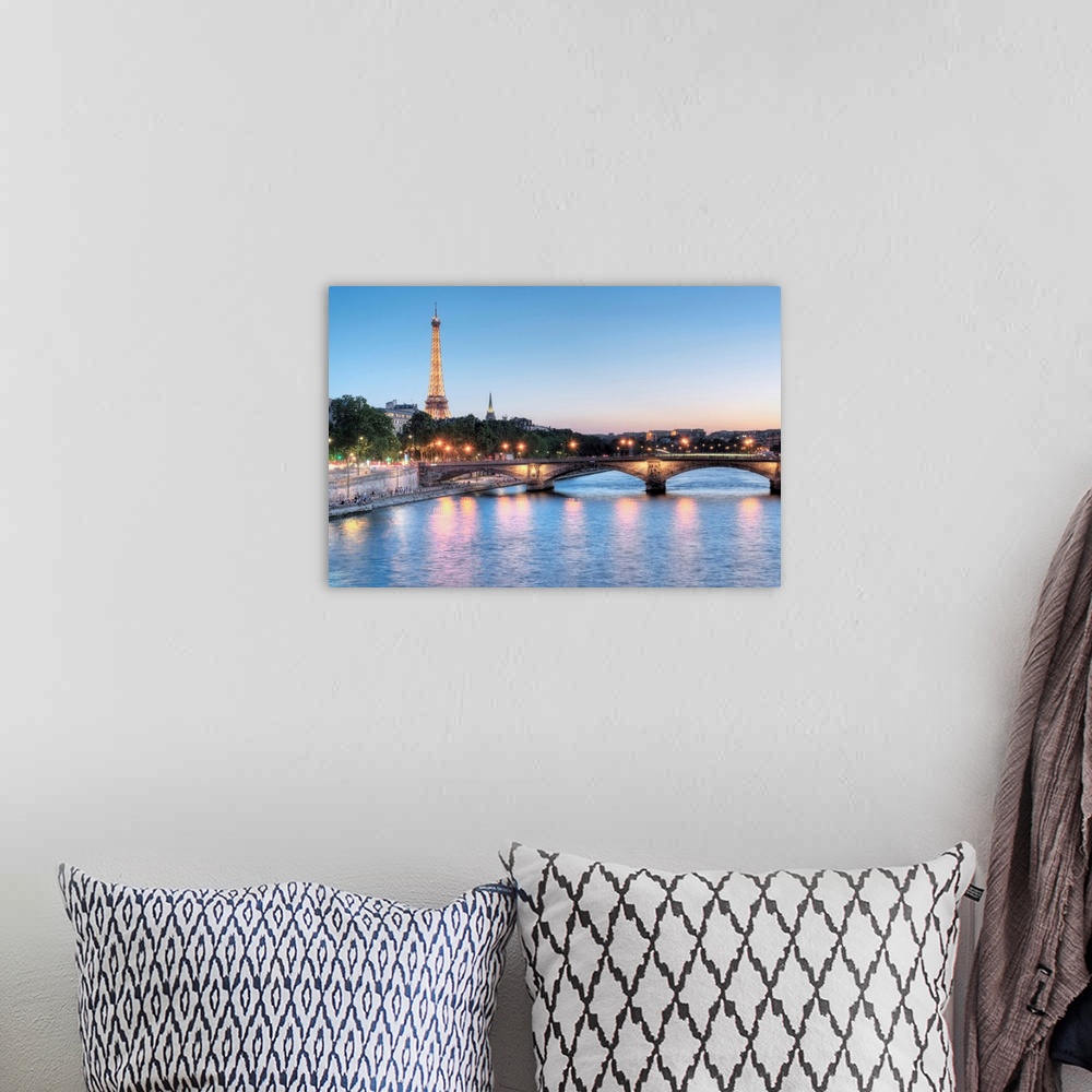 A bohemian room featuring A photograph of the Seine river in Paris with the Eiffel Tower in the background.
