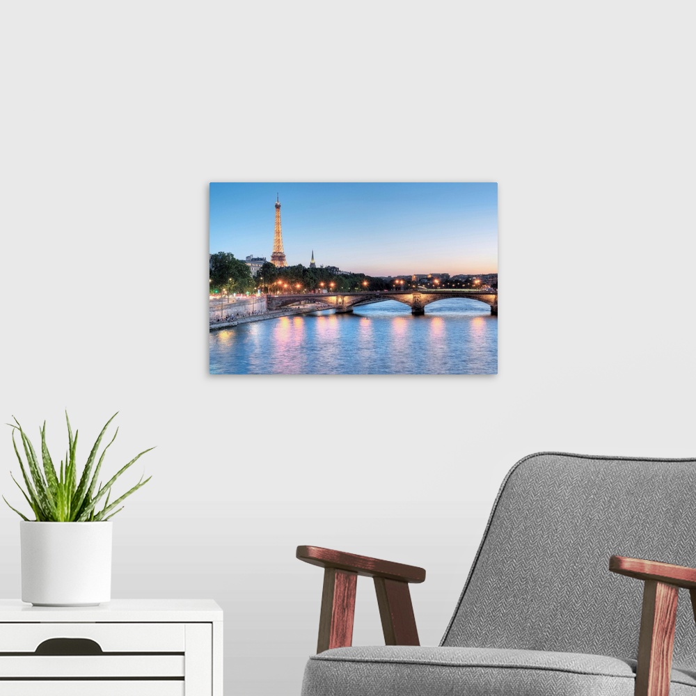 A modern room featuring A photograph of the Seine river in Paris with the Eiffel Tower in the background.