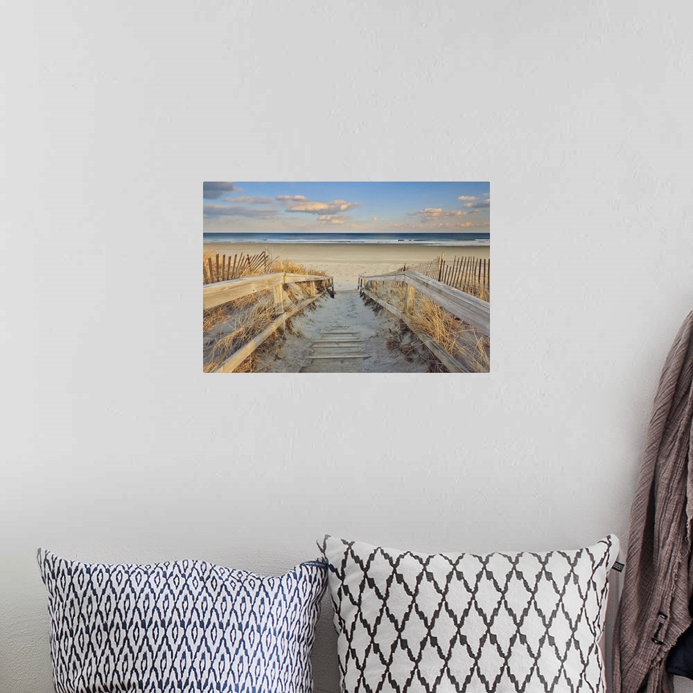 A bohemian room featuring A photograph of an idyllic scene with a wooden walkway leading down to a sandy secluded beach.