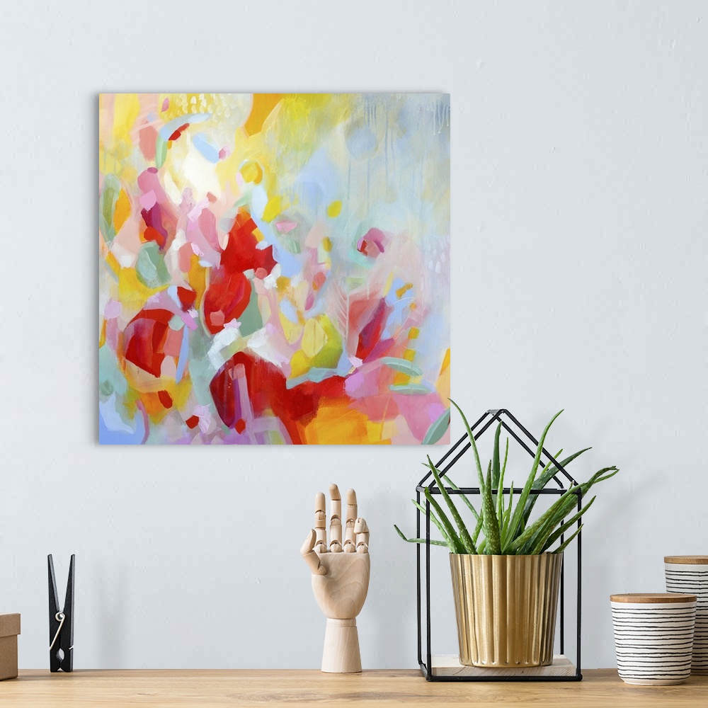 A bohemian room featuring Contemporary abstract artwork in vibrant red, yellow, and pink, resembling a flower garden.